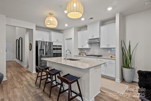 9021 Myrna Dr, Gastonia, NC 28056 - kitchen featuring appliances with stainless steel finishes, under cabinet range hood, white cabinets, backsplash, and recessed lighting