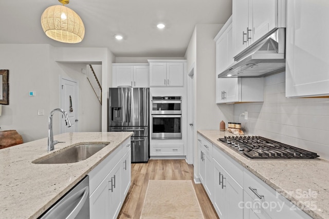 9021 Myrna Dr, Gastonia, NC 28056 - kitchen featuring appliances with stainless steel finishes, under cabinet range hood, white cabinetry, light wood-type flooring, and recessed lighting