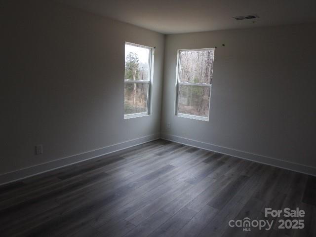 212 Sugar Hill Rd, Troutman, NC 28166 - spare room with dark wood-style flooring and baseboards