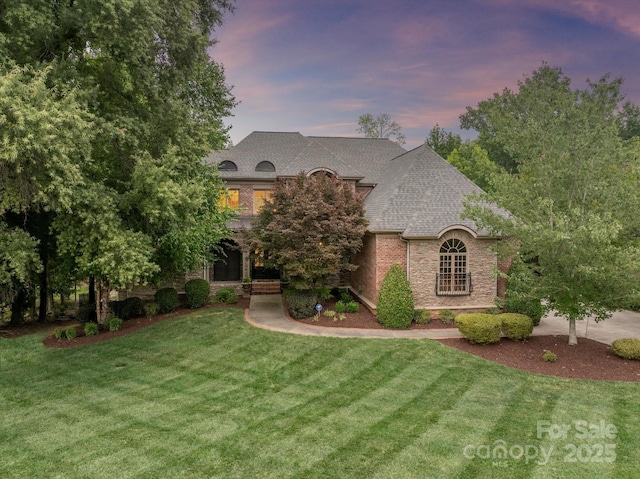 1505 Hawkstone Dr, Waxhaw, NC 28173 - french country inspired facade with a front lawn, roof with shingles, stone siding, and brick siding