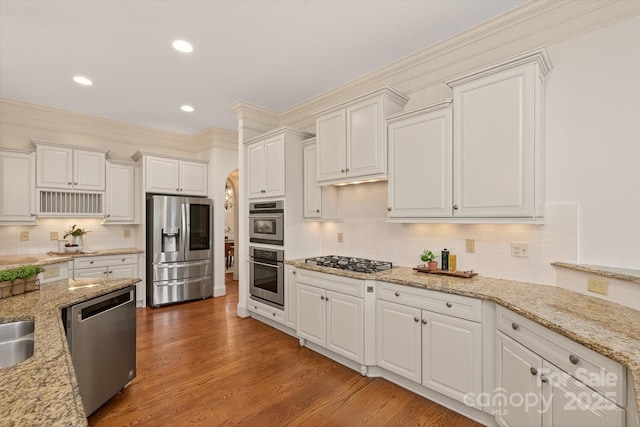1505 Hawkstone Dr, Waxhaw, NC 28173 - kitchen with stainless steel appliances, decorative backsplash, white cabinets, and recessed lighting