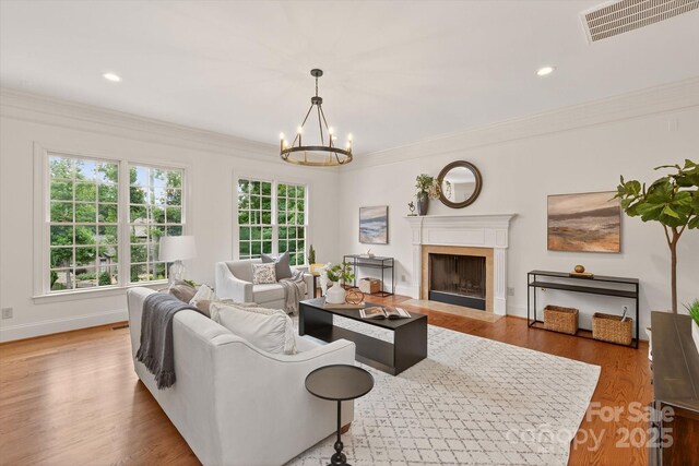 1505 Hawkstone Dr, Waxhaw, NC 28173 - living area featuring a chandelier, a high end fireplace, crown molding, wood finished floors, and recessed lighting