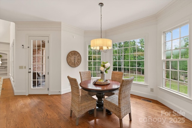 1505 Hawkstone Dr, Waxhaw, NC 28173 - dining space with a chandelier, light wood-type flooring, and crown molding