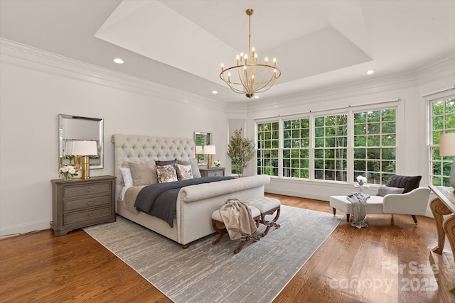 1505 Hawkstone Dr, Waxhaw, NC 28173 - bedroom with a chandelier, a raised ceiling, crown molding, recessed lighting, and wood finished floors
