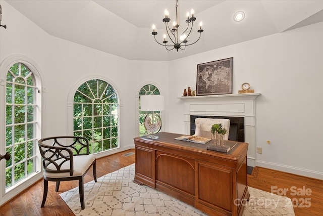 1505 Hawkstone Dr, Waxhaw, NC 28173 - home office featuring a chandelier, a fireplace, light wood-type flooring, and recessed lighting
