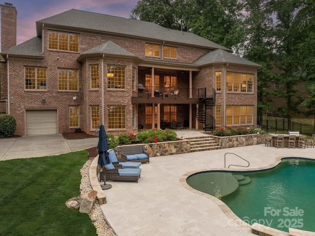 1505 Hawkstone Dr, Waxhaw, NC 28173 - rear view of house with stairway, brick siding, a patio, a chimney, and concrete driveway