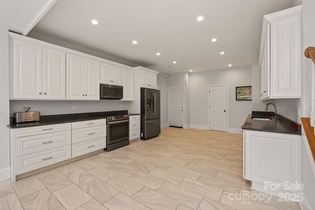 1505 Hawkstone Dr, Waxhaw, NC 28173 - kitchen featuring appliances with stainless steel finishes, dark countertops, recessed lighting, and white cabinets