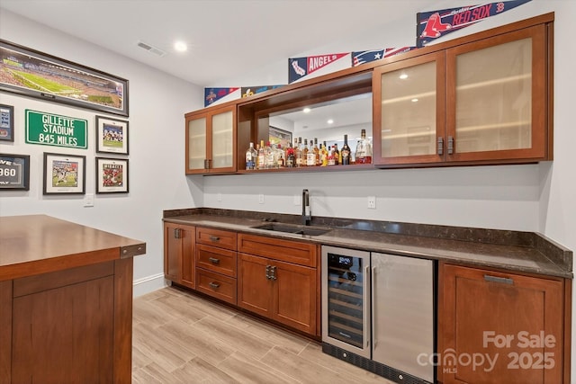 1505 Hawkstone Dr, Waxhaw, NC 28173 - indoor wet bar featuring beverage cooler, light wood-style flooring, and recessed lighting