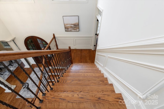 1505 Hawkstone Dr, Waxhaw, NC 28173 - staircase featuring a decorative wall, wood finished floors, and wainscoting