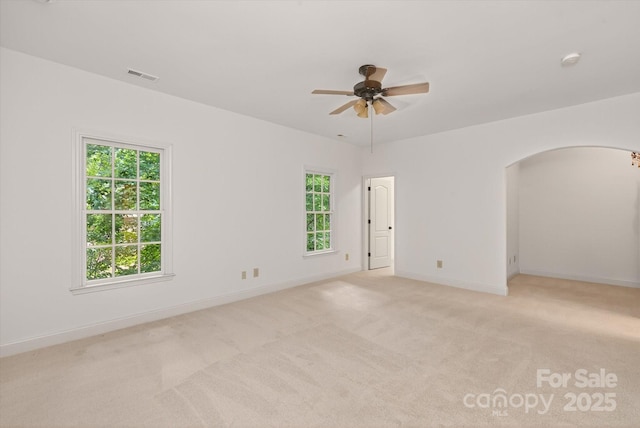 1505 Hawkstone Dr, Waxhaw, NC 28173 - spare room featuring arched walkways, ceiling fan, plenty of natural light, and light carpet