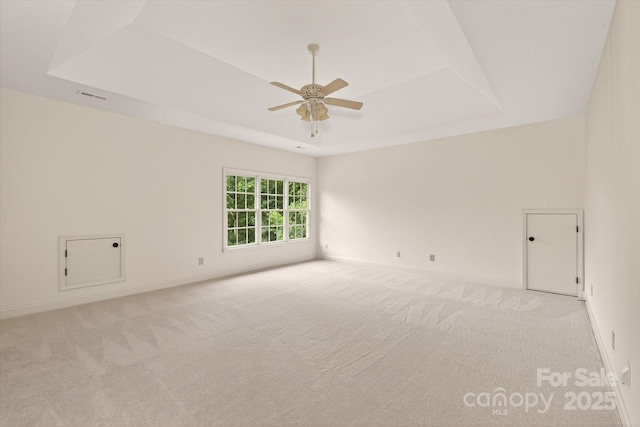1505 Hawkstone Dr, Waxhaw, NC 28173 - empty room featuring a raised ceiling, ceiling fan, and light carpet