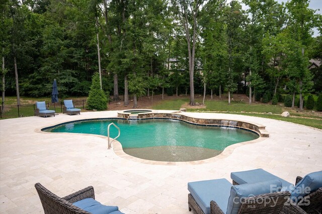 1505 Hawkstone Dr, Waxhaw, NC 28173 - view of swimming pool featuring a patio area, a pool with connected hot tub, and view of scattered trees
