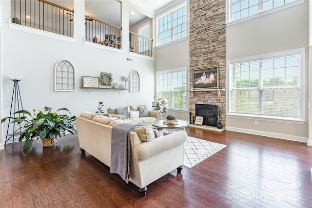 208 Canoe Pole Ln, Mooresville, NC 28117 - living room featuring a fireplace, a towering ceiling, and dark wood-style floors