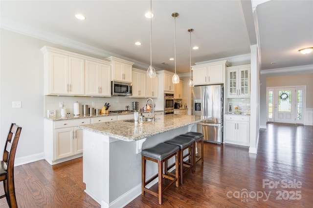208 Canoe Pole Ln, Mooresville, NC 28117 - kitchen featuring appliances with stainless steel finishes, dark wood-style floors, tasteful backsplash, a kitchen bar, and white cabinetry