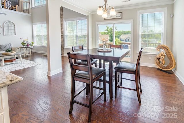 208 Canoe Pole Ln, Mooresville, NC 28117 - dining space featuring crown molding, plenty of natural light, dark wood finished floors, and a chandelier