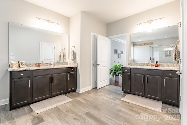 208 Canoe Pole Ln, Mooresville, NC 28117 - full bathroom featuring two vanities, wood finished floors, and a shower stall
