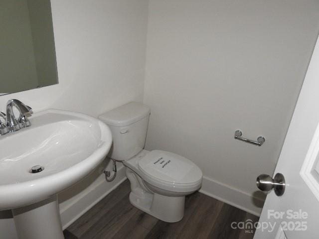 232 Sugar Hill Rd, Troutman, NC 28166 - half bath featuring wood finished floors and toilet