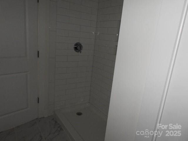 232 Sugar Hill Rd, Troutman, NC 28166 - bathroom featuring a shower stall and marble look tiles