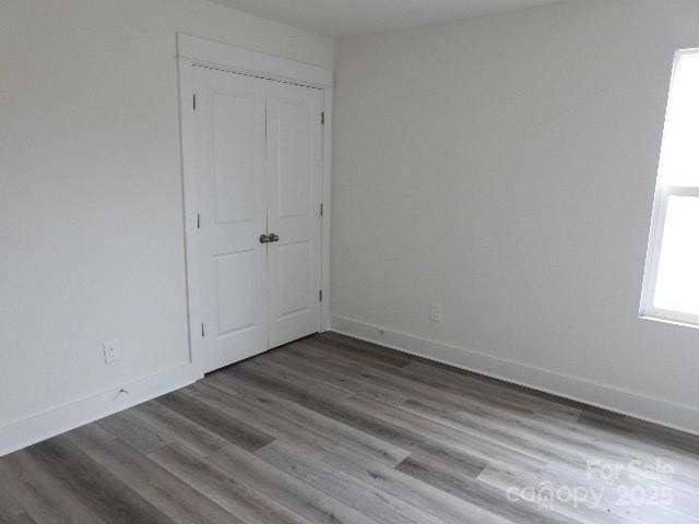 232 Sugar Hill Rd, Troutman, NC 28166 - unfurnished bedroom featuring a closet and wood finished floors
