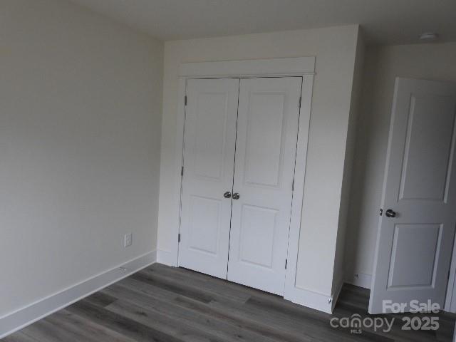 232 Sugar Hill Rd, Troutman, NC 28166 - unfurnished bedroom featuring dark wood-style floors and a closet