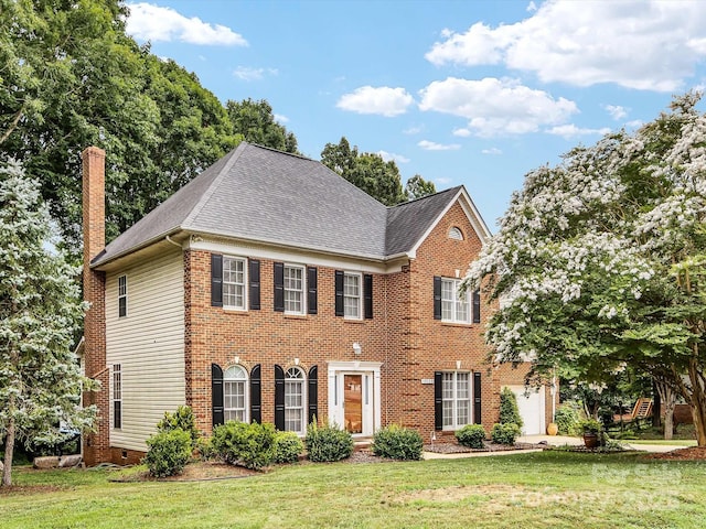 15139 Wiltshire Manor Dr, Charlotte, NC 28278 - colonial home featuring roof with shingles, a front yard, a chimney, a garage, and brick siding