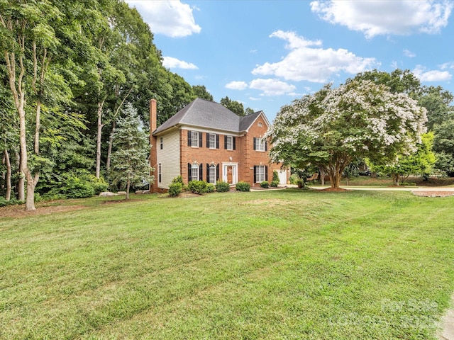 15139 Wiltshire Manor Dr, Charlotte, NC 28278 - colonial home with brick siding, a chimney, and a front lawn
