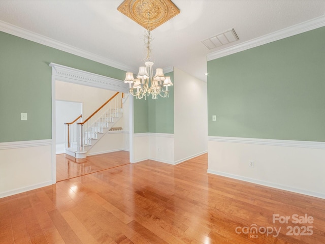 15139 Wiltshire Manor Dr, Charlotte, NC 28278 - empty room with a chandelier, wood finished floors, stairway, and crown molding