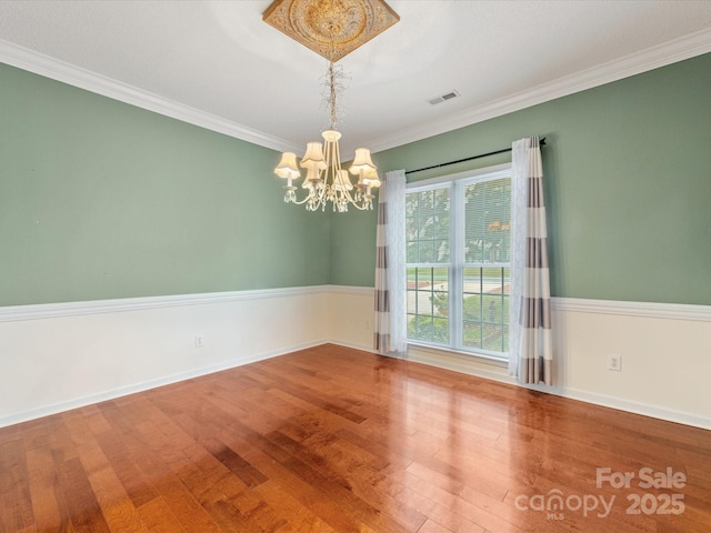 15139 Wiltshire Manor Dr, Charlotte, NC 28278 - unfurnished room with a chandelier, wood finished floors, and crown molding