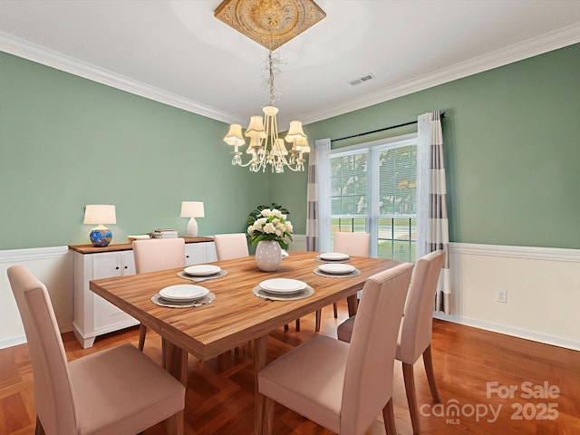 15139 Wiltshire Manor Dr, Charlotte, NC 28278 - dining area featuring a chandelier, ornamental molding, and light wood finished floors