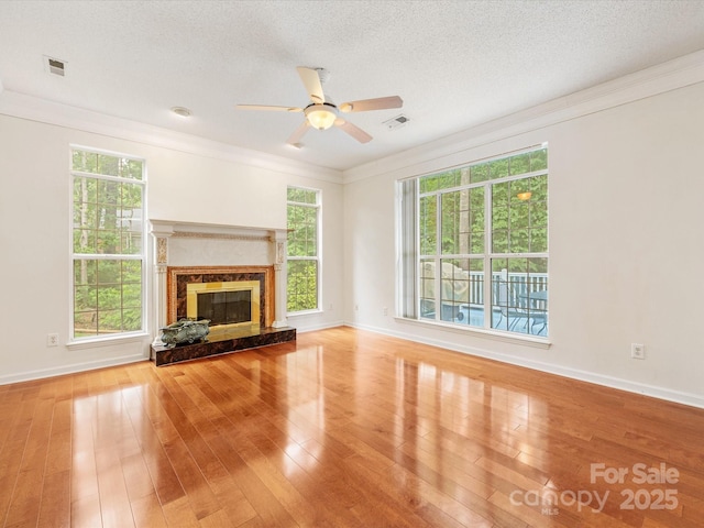 15139 Wiltshire Manor Dr, Charlotte, NC 28278 - unfurnished living room with a ceiling fan, crown molding, wood finished floors, plenty of natural light, and a textured ceiling