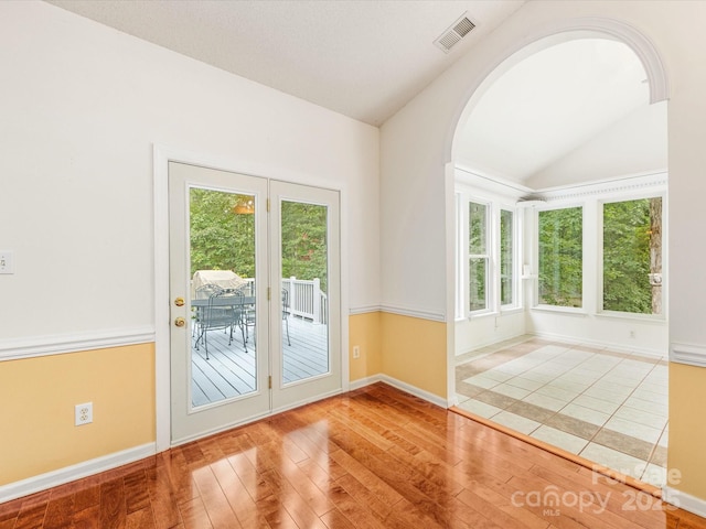 15139 Wiltshire Manor Dr, Charlotte, NC 28278 - spare room featuring lofted ceiling, hardwood / wood-style flooring, and arched walkways