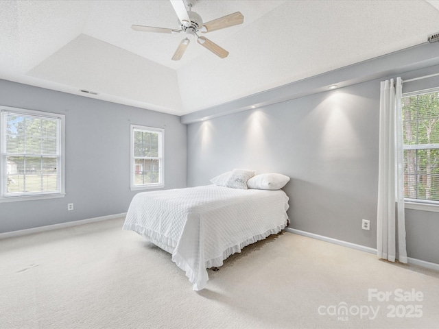 15139 Wiltshire Manor Dr, Charlotte, NC 28278 - carpeted bedroom featuring multiple windows, a tray ceiling, and a ceiling fan
