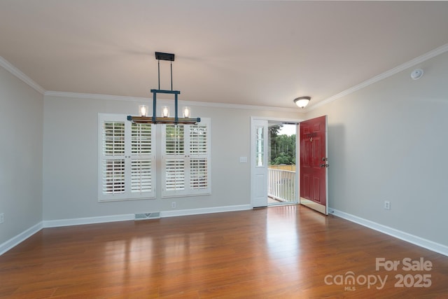 1408 Wildwood Dr, Kannapolis, NC 28081 - spare room featuring a chandelier, ornamental molding, wood finished floors, and a smoke detector