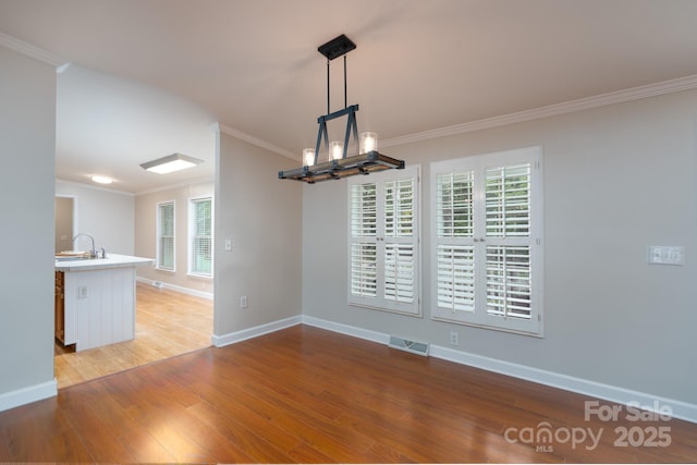 1408 Wildwood Dr, Kannapolis, NC 28081 - unfurnished dining area with ornamental molding, light wood-style flooring, and a chandelier