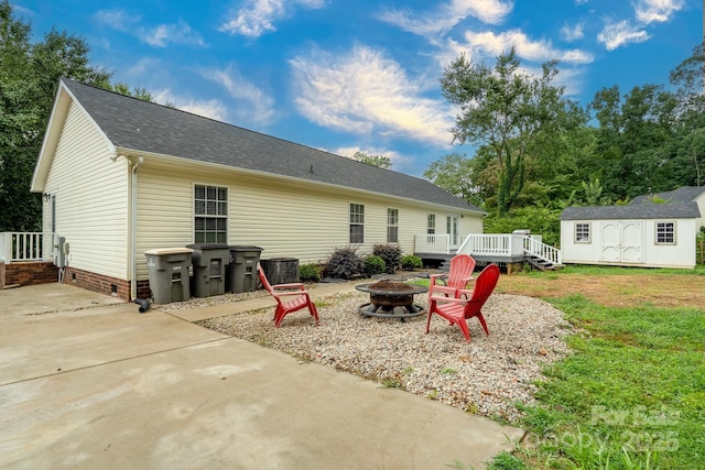 1408 Wildwood Dr, Kannapolis, NC 28081 - back of house with a fire pit, a shed, a wooden deck, a shingled roof, and crawl space