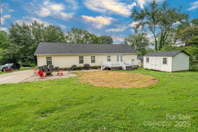 1408 Wildwood Dr, Kannapolis, NC 28081 - back of house featuring a deck, an outdoor fire pit, a storage unit, and a lawn