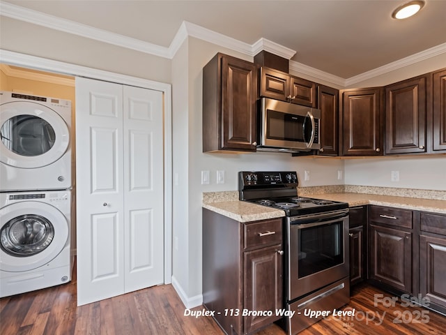 113 Bronco Way, Waynesville, NC 28785 - kitchen with stainless steel appliances, stacked washer / drying machine, dark wood-type flooring, light countertops, and crown molding