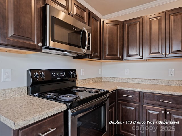 113 Bronco Way, Waynesville, NC 28785 - kitchen with black / electric stove, stainless steel microwave, dark brown cabinetry, light countertops, and ornamental molding