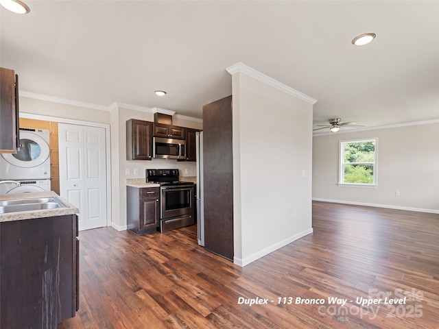 113 Bronco Way, Waynesville, NC 28785 - kitchen with appliances with stainless steel finishes, estacked washer and dryer, dark brown cabinets, ceiling fan, and light countertops