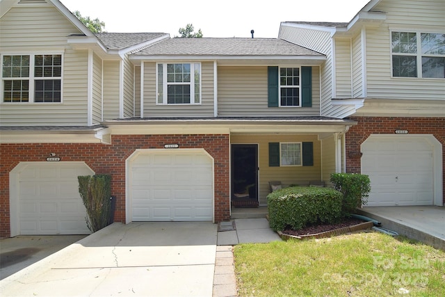 2620 Brackley Pl NW, Concord, NC 28027 - traditional home with a garage, driveway, brick siding, covered porch, and a shingled roof