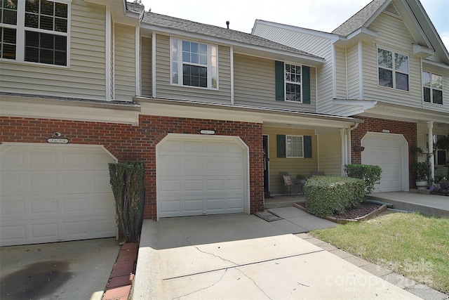2620 Brackley Pl NW, Concord, NC 28027 - view of front of property featuring an attached garage, brick siding, driveway, and a shingled roof