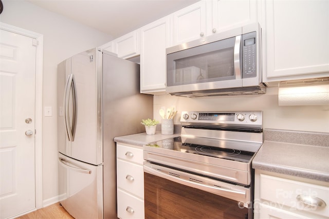 2620 Brackley Pl NW, Concord, NC 28027 - kitchen featuring appliances with stainless steel finishes, white cabinets, and light countertops