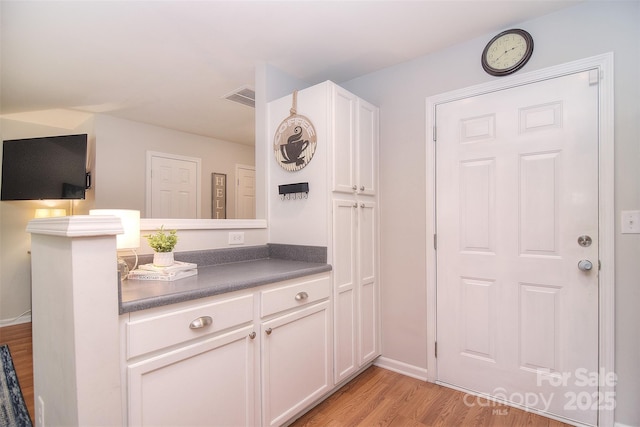 2620 Brackley Pl NW, Concord, NC 28027 - kitchen with light wood-type flooring, dark countertops, and white cabinets