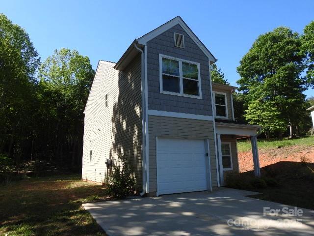 118 Carrisa Ln, Troutman, NC 28166 - view of front facade featuring a garage and driveway