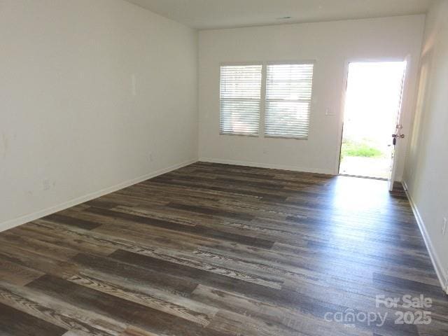 118 Carrisa Ln, Troutman, NC 28166 - empty room featuring plenty of natural light and dark wood finished floors