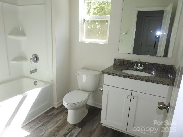 118 Carrisa Ln, Troutman, NC 28166 - bathroom featuring vanity, wood finished floors, and bathing tub / shower combination