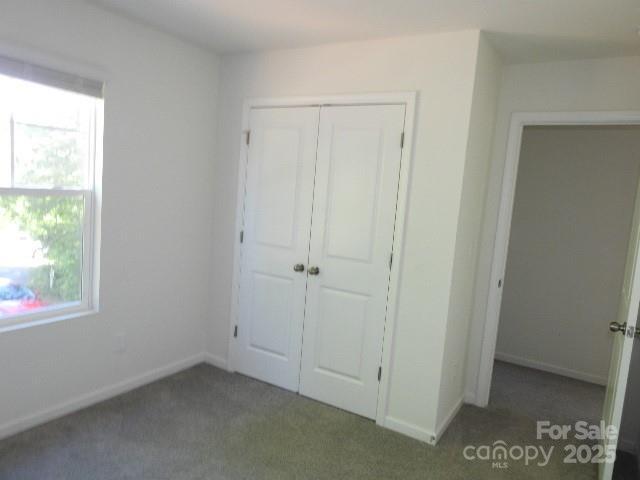 118 Carrisa Ln, Troutman, NC 28166 - unfurnished bedroom featuring a closet and carpet floors