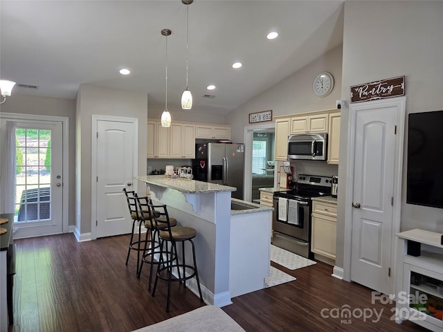 1300 Bethpage Rd, Kannapolis, NC 28081 - kitchen with stainless steel appliances, cream cabinets, a breakfast bar, dark wood-style floors, and recessed lighting