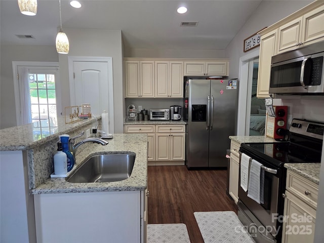 1300 Bethpage Rd, Kannapolis, NC 28081 - kitchen with appliances with stainless steel finishes, cream cabinets, dark wood-style floors, recessed lighting, and vaulted ceiling