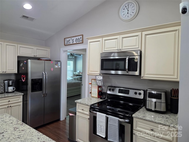 1300 Bethpage Rd, Kannapolis, NC 28081 - kitchen featuring appliances with stainless steel finishes, lofted ceiling, cream cabinets, and a ceiling fan
